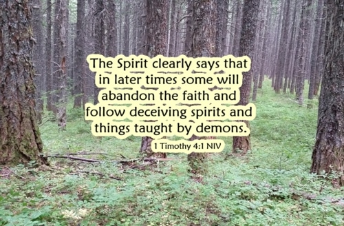 A dense forest with 1 Timothy 4:1. A warning against the teachings of demons